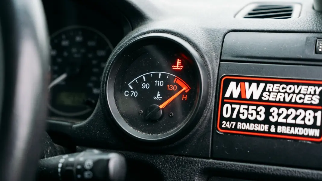 Car temperature gauge in the red zone on dashboard warning of overheating